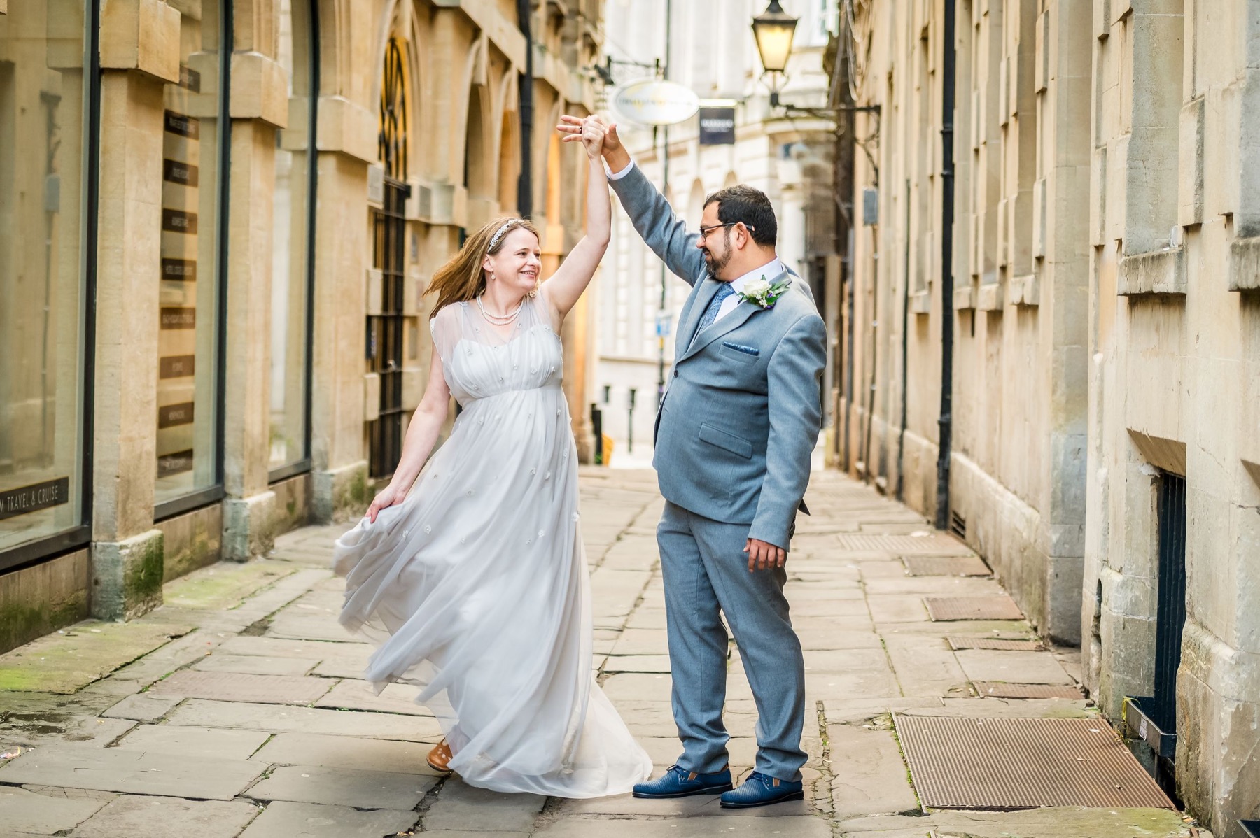 Wedding couple dancing together on a Bath street