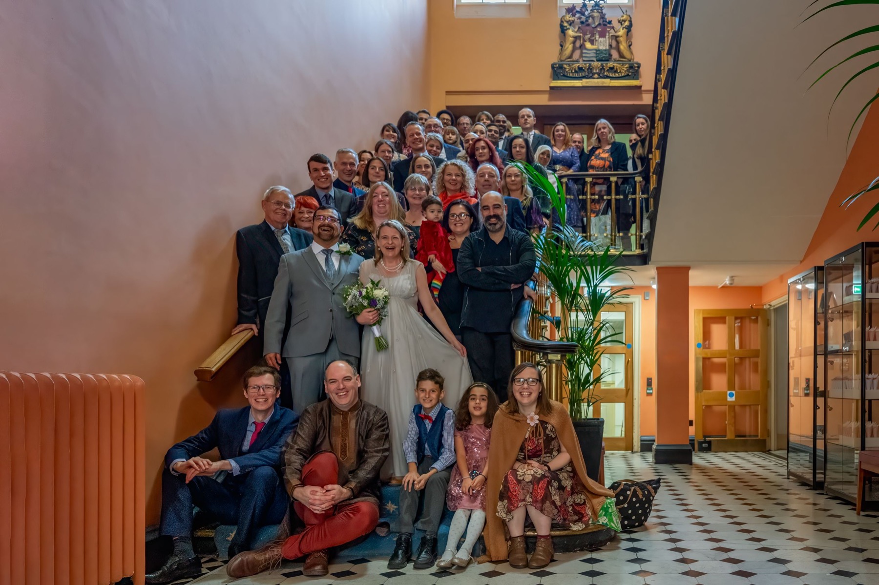 Wedding party gathered on an indoor staircase